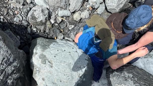 Wife rescues husband from a 700-pound boulder