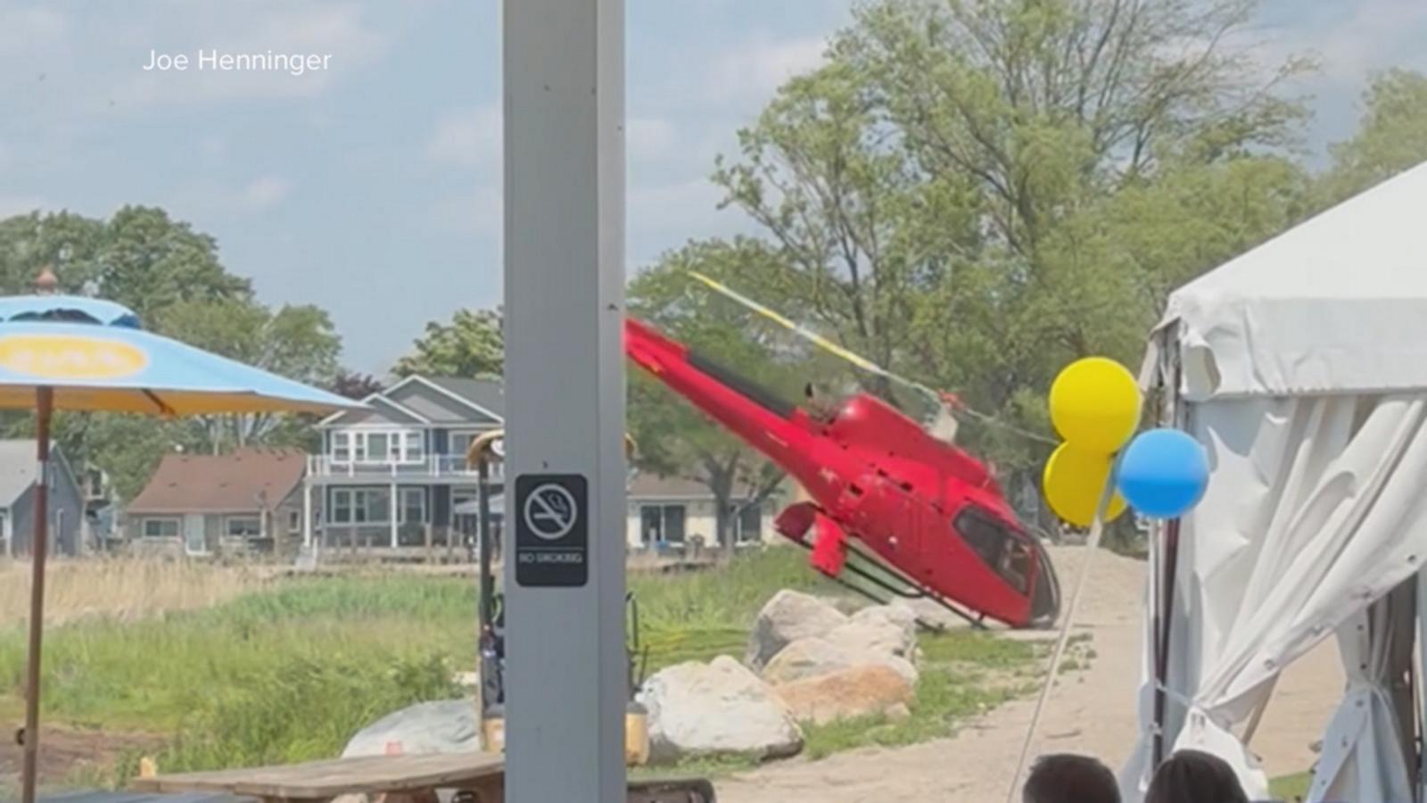 WATCH:  Helicopter flips over while attempting to land outside Michigan restaurant
