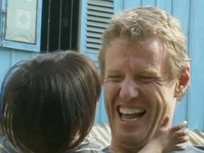 A picture of Scott Neeson holding a child.