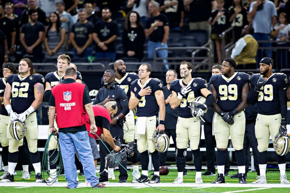 PHOTO: Drew Brees #9 of the New Orleans Saints stands with his hand over his heart during the playing of the National Anthem before a game against the Los Angeles Rams during week 4 of the preseason, Aug. 30, 2018 in New Orleans.