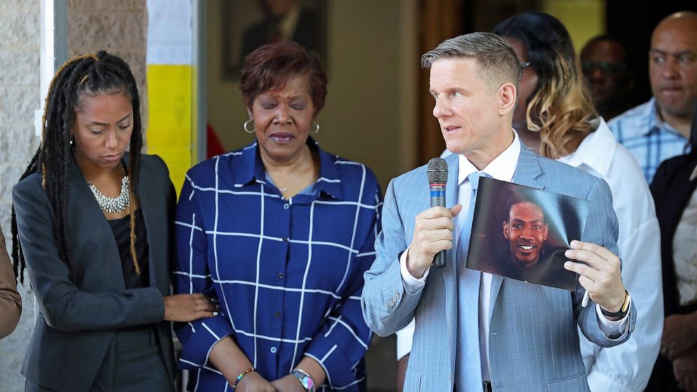 PHOTO: Attorney Bobby DiCello, right, holds up a photograph of Jayland Walker as Paige White, left, comforts Jayland's mother Pamela Walker during a press conference at St. Ashworth Temple on June 30, 2022, in Akron, Ohio.