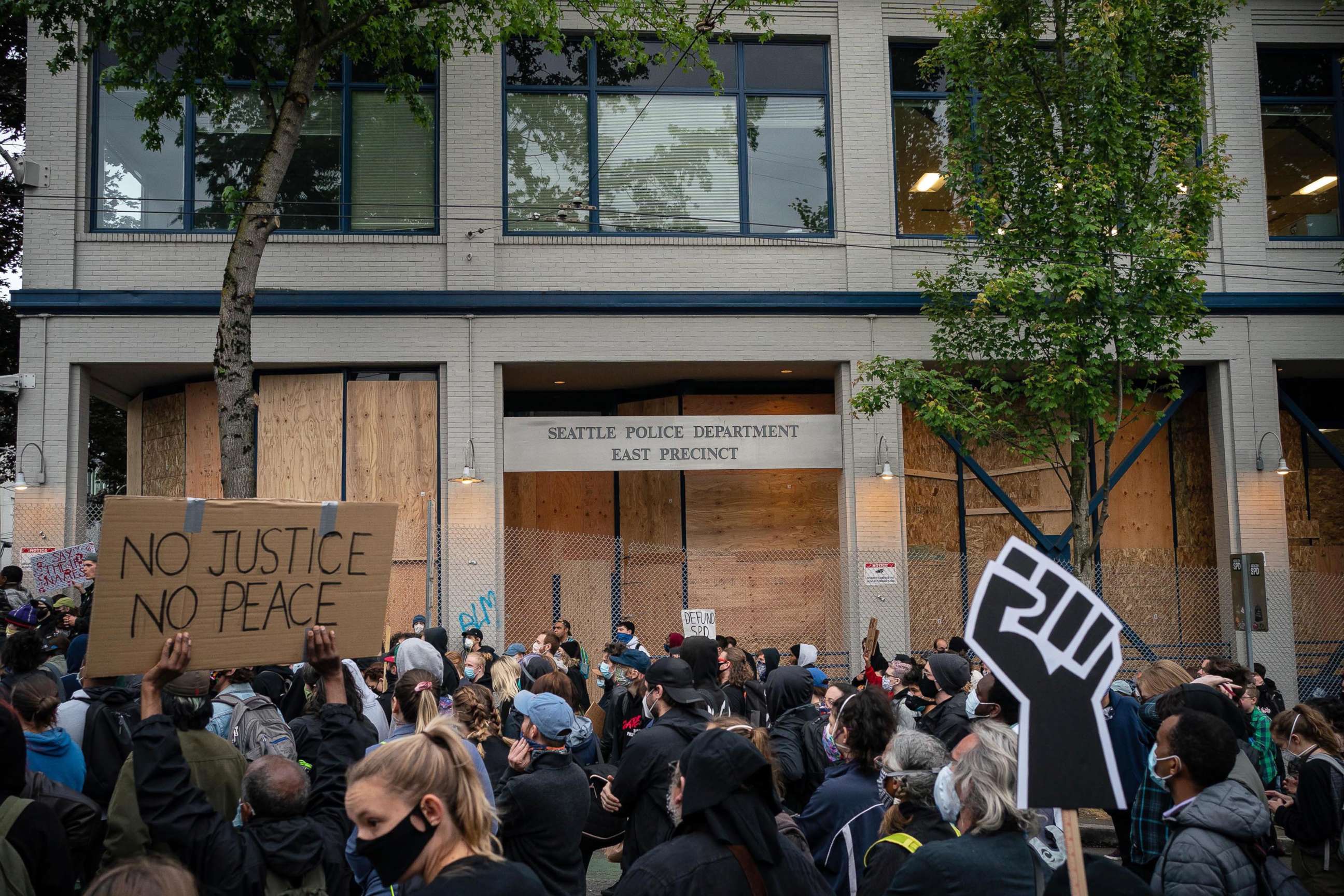 PHOTO: Demonstrators hold a rally and teach-in outside of the Seattle Police Departments East Precinct, which has been boarded up and protected by fencing, June 8, 2020 in Seattle. 