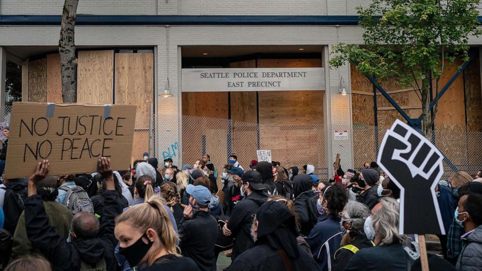 PHOTO: Demonstrators hold a rally and teach-in outside of the Seattle Police Departments East Precinct, which has been boarded up and protected by fencing, June 8, 2020 in Seattle. 