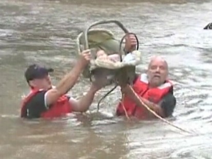 VIDEO: Firefighters helped get the four-week-old infant to higher ground.