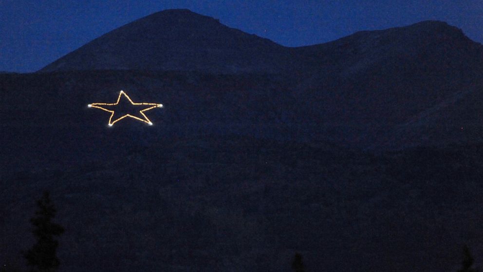 The Joint Base Elmendorf-Richardson star is Illuminated on the side of Mount Gordon Lyon on Wednesday, Sept. 11, 2019, just east of Anchorage, Alaska, in observation of the 18th anniversary of the terrorist attacks. A crew from the base went to light