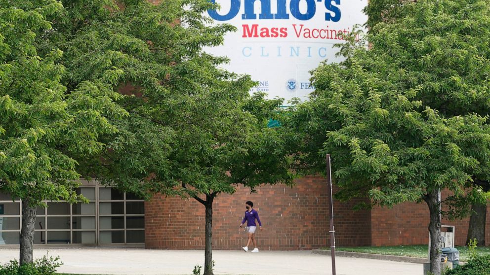 FILE - In this May 25, 2021, file photo, a man walks by the entrance for Ohio's COVID-19 mass vaccination clinic at Cleveland State University in Cleveland. Ohio plans to announce its third pair of Ohio Vax-a-Million winners Wednesday evening, June 9