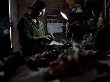 A Bolivian artist carves faces of the departed onto Day of the Dead bread