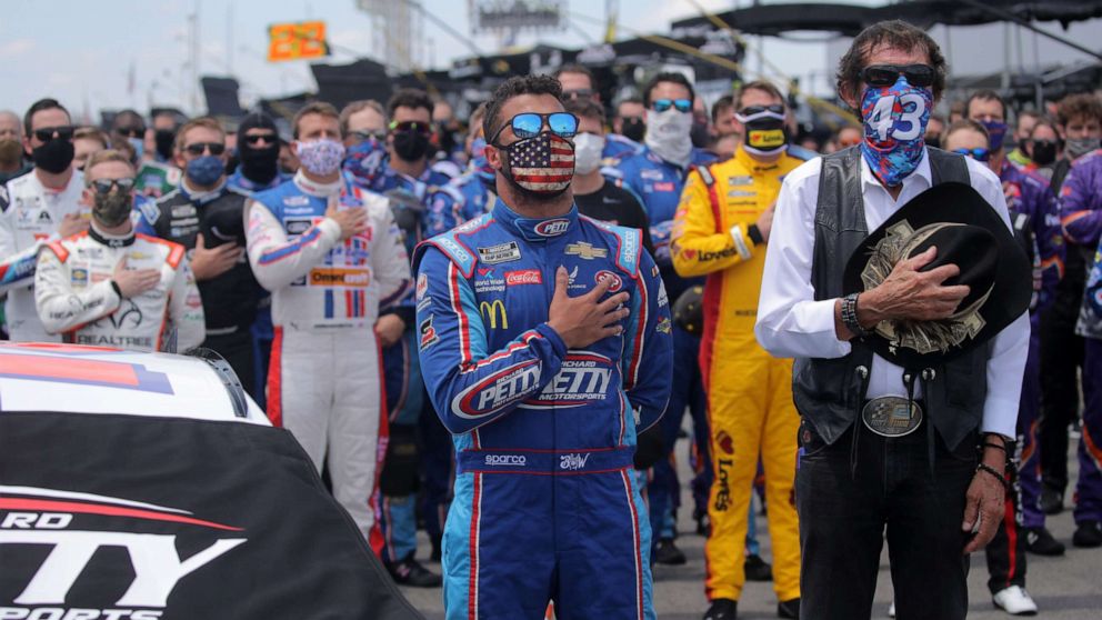 PHOTO: Bubba Wallace, driver of the #43 Victory Junction Chevrolet, and team owner, and NASCAR Hall of Famer Richard Petty stand for the national anthem prior to the NASCAR Cup Series GEICO 500 at Talladega Superspeedway on June 22, 2020.