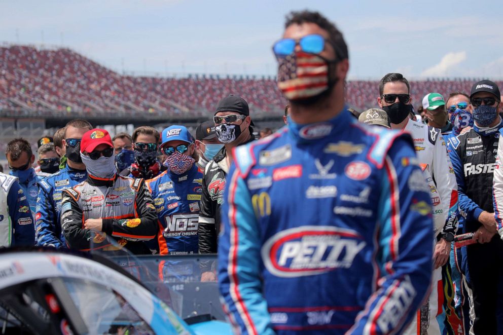 PHOTO: NASCAR drivers stand in solidarity with Bubba Wallace during the national anthem prior to the NASCAR Cup Series GEICO 500 at Talladega Superspeedway on June 22, 2020 in Talladega, Alabama.